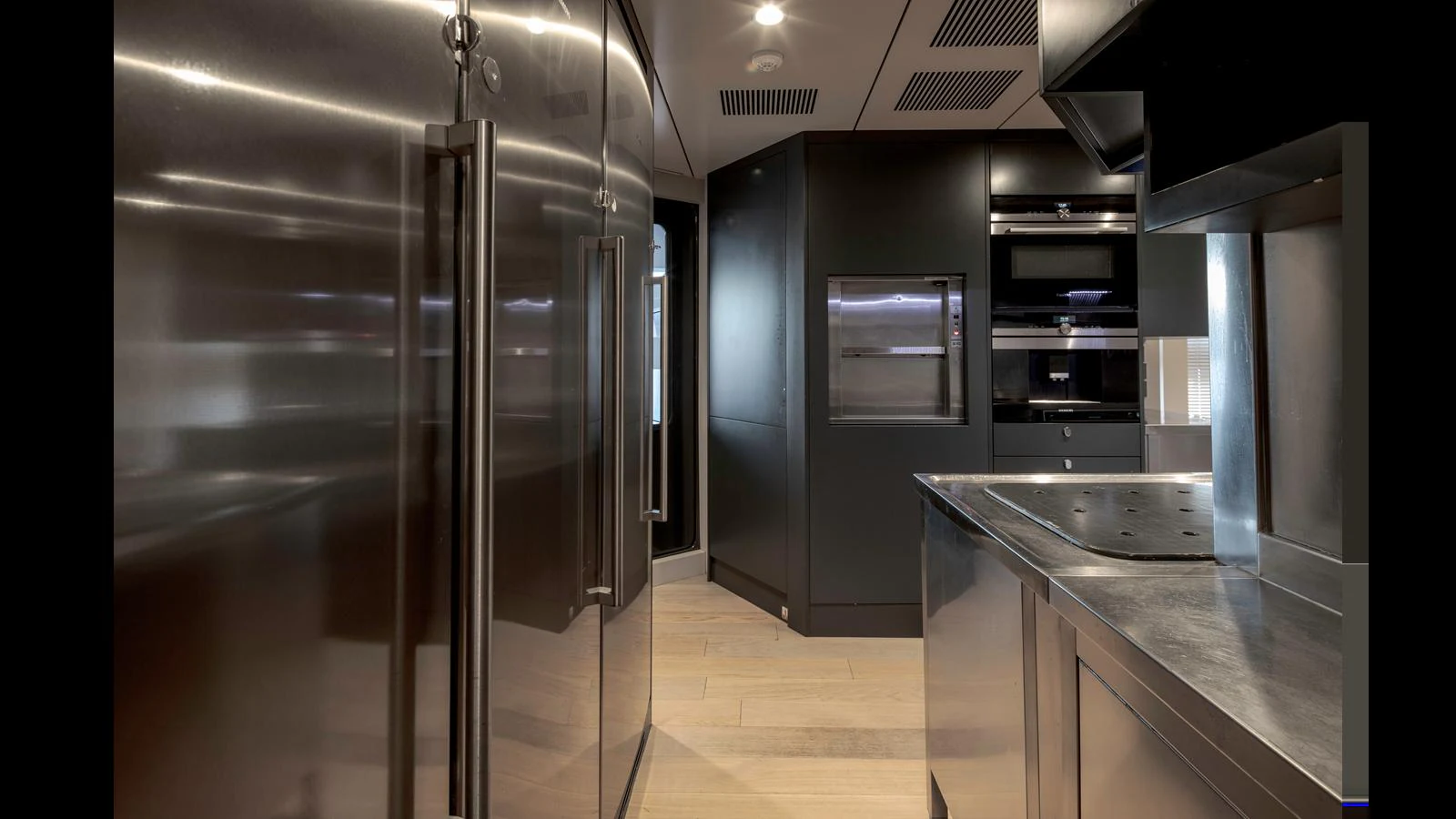 The sleek and modern galley features stainless steel appliances and ample counter space. aboard Q.M Yacht for Sale