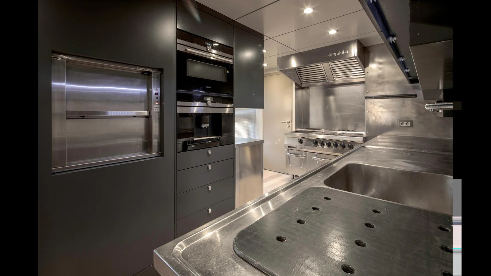 The yacht's galley is equipped with modern appliances and ample counter space for gourmet meal preparation. aboard Q.M Yacht for Sale