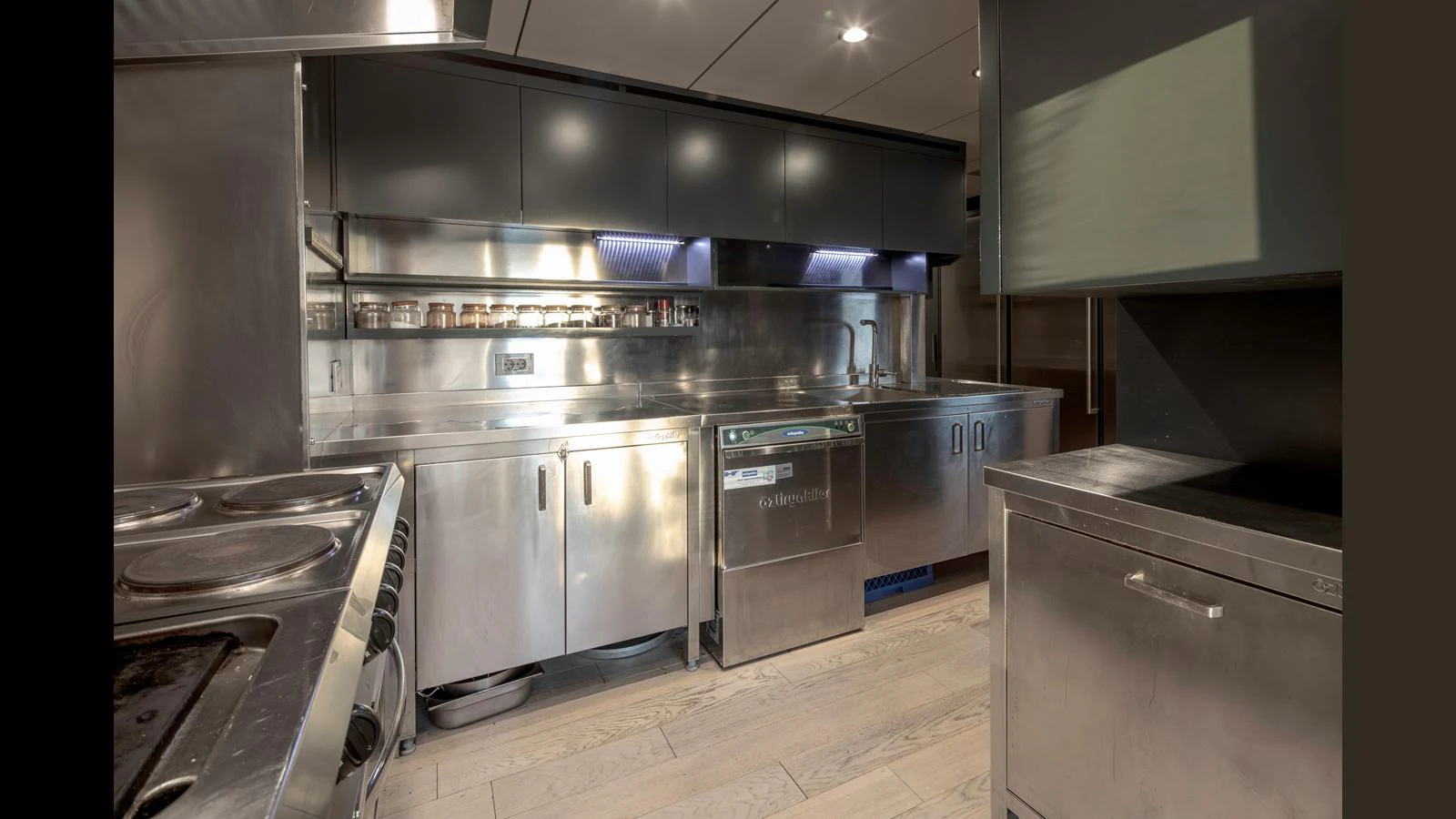 The yacht's galley features modern stainless steel appliances and ample counter space. aboard Q.M Yacht for Sale