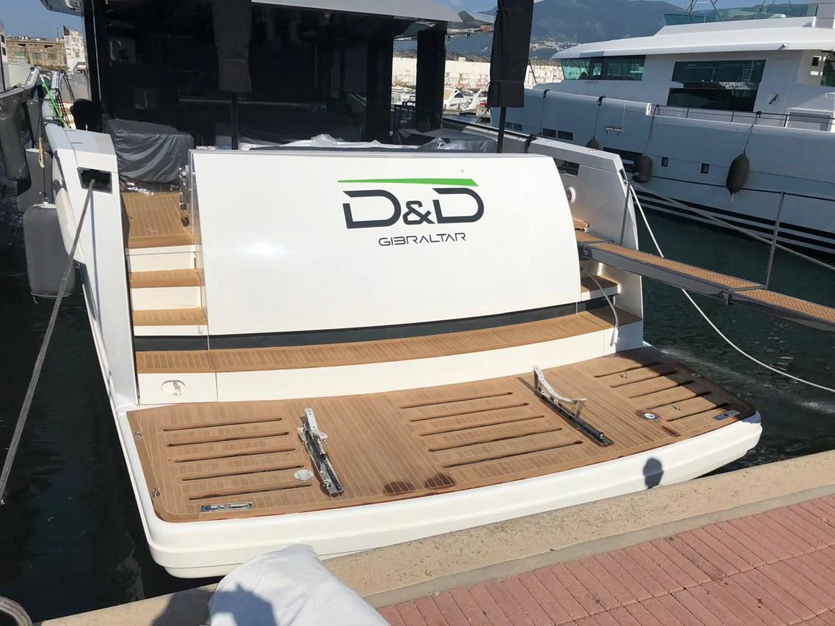 The yacht's stern features a spacious swim platform with elegant teak decking. aboard D&D Yacht for Sale