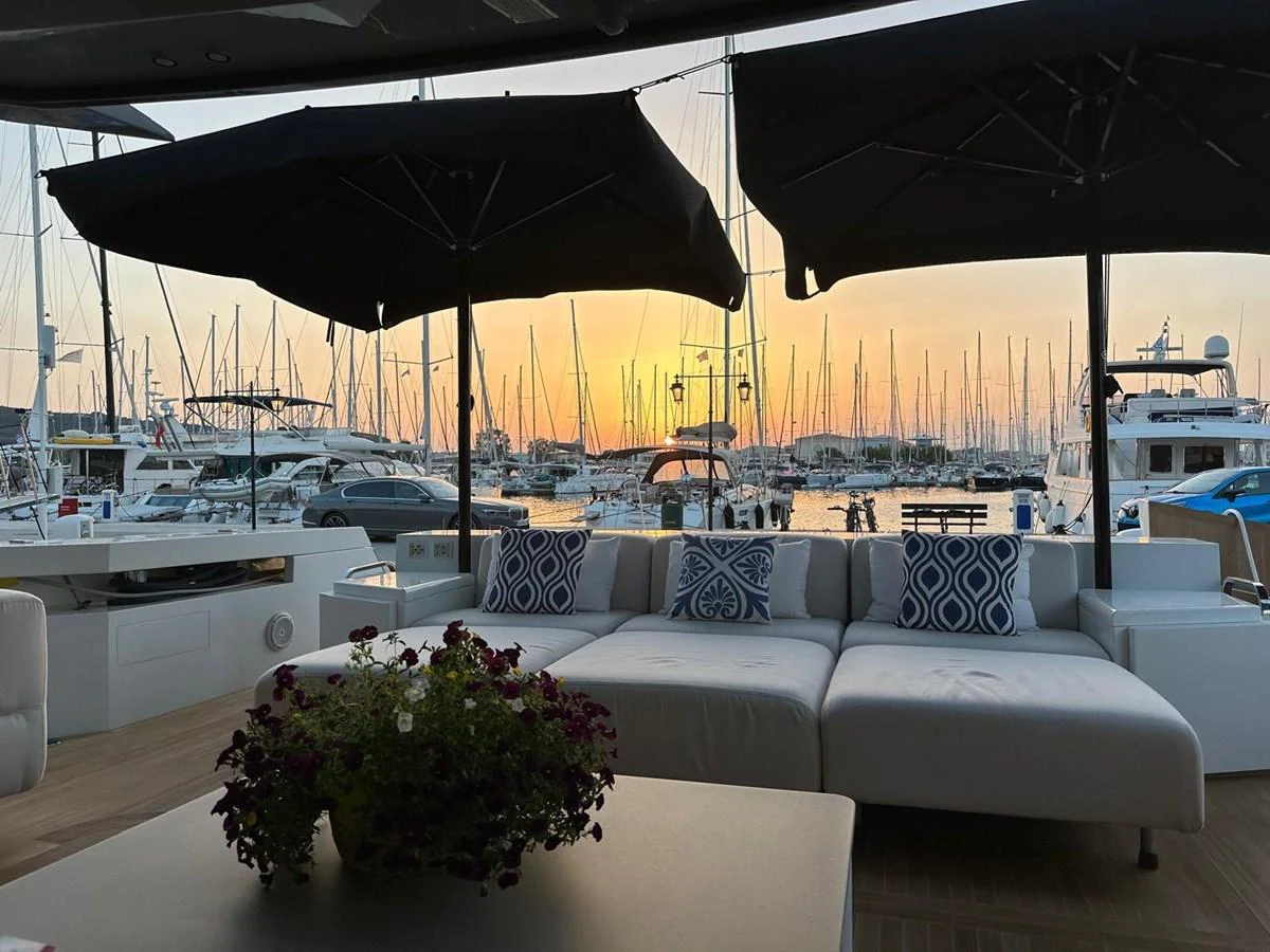 The aft deck offers a cozy seating area with a stunning sunset view over the marina. aboard D&D Yacht for Sale