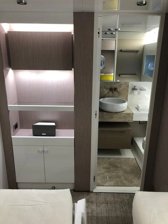 A modern yacht bathroom with sleek fixtures and ample storage space. aboard D&D Yacht for Sale