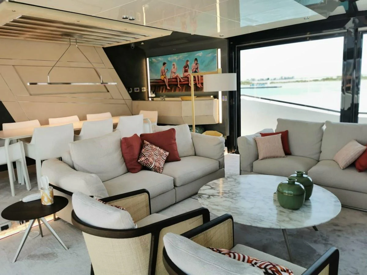 The salon features modern furnishings with ample seating and a stylish dining area. aboard D&D Yacht for Sale
