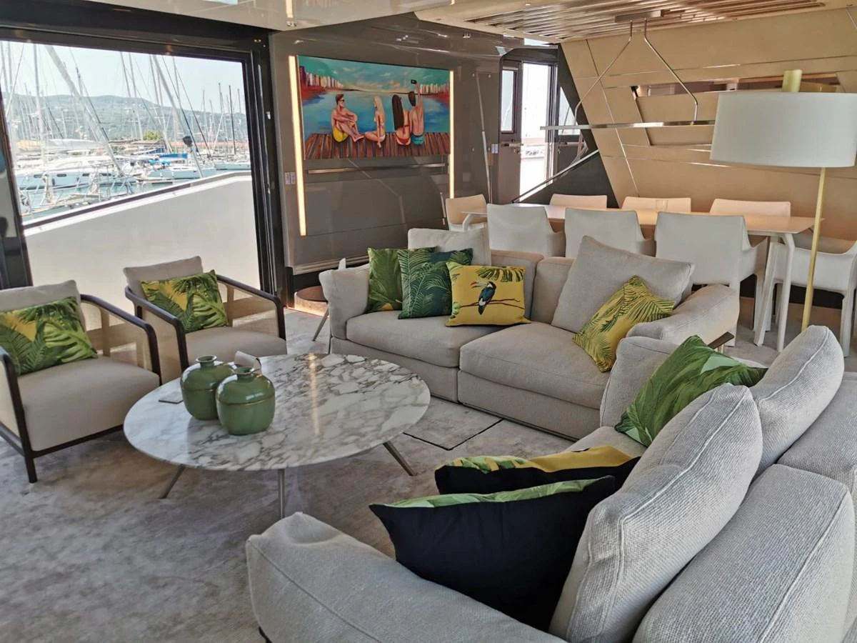 The salon features plush seating, a marble coffee table, and vibrant decor, offering a luxurious and comfortable space for relaxation. aboard D&D Yacht for Sale