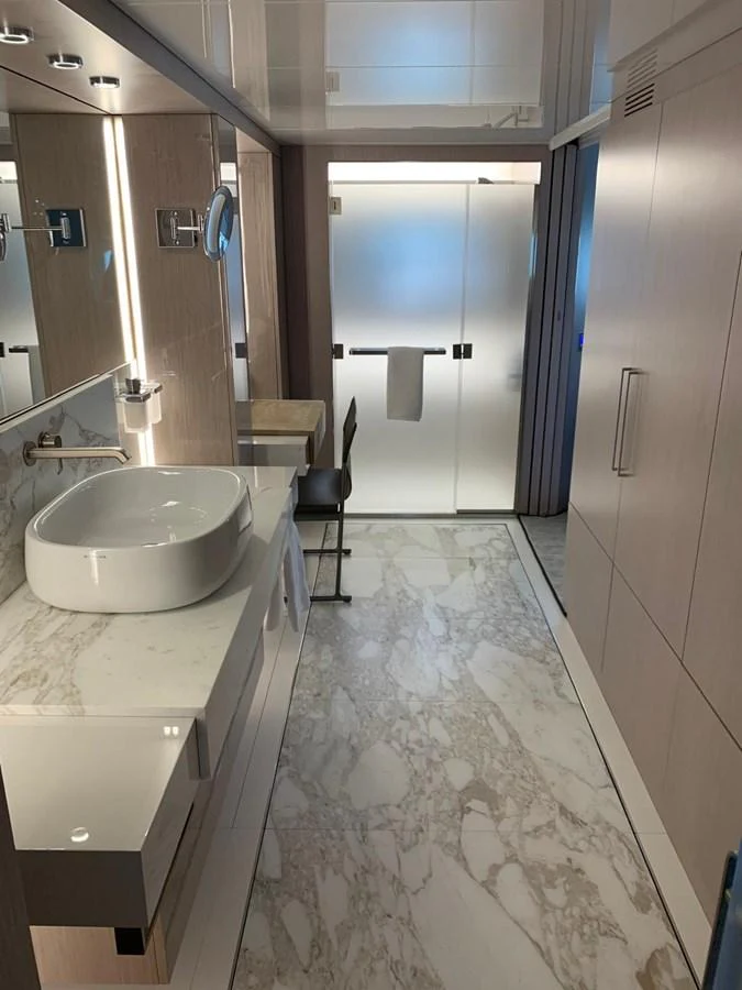 A luxurious yacht bathroom featuring modern fixtures and elegant marble flooring. aboard D&D Yacht for Sale