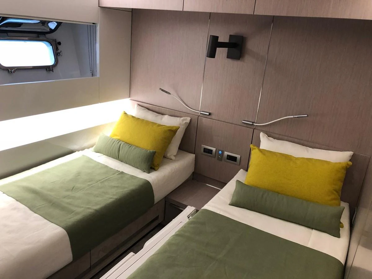 The twin stateroom features modern design with comfortable twin beds and stylish decor. aboard D&D Yacht for Sale