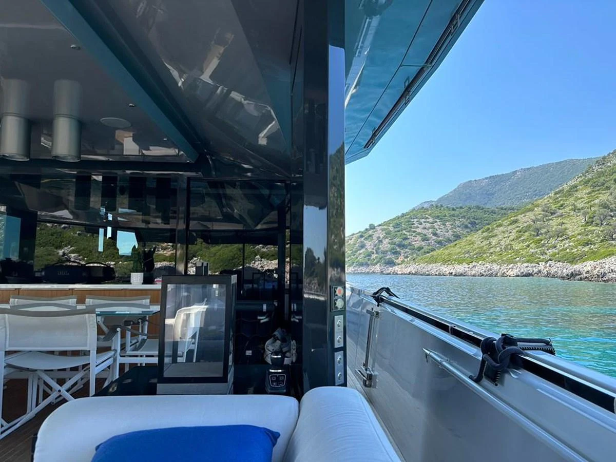 The aft deck offers a comfortable seating area with a scenic view of the surrounding waters and landscape. aboard D&D Yacht for Sale