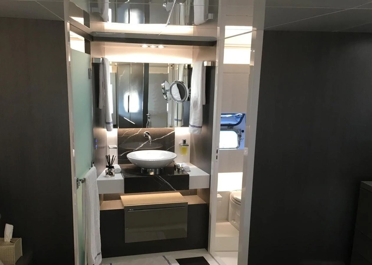 The yacht's bathroom features modern fixtures and a sleek design. aboard D&D Yacht for Sale