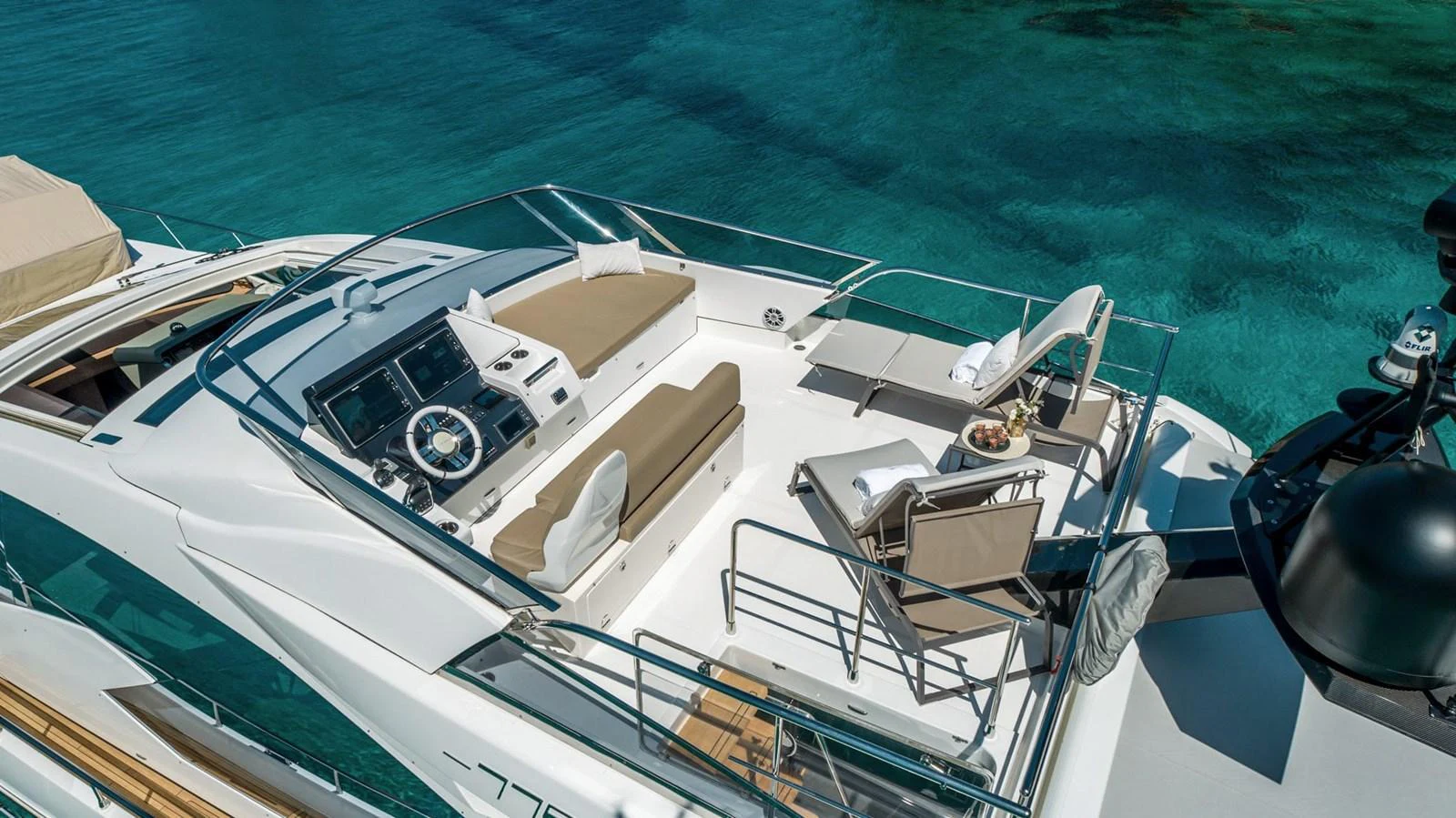 The flybridge offers a luxurious space for relaxation with stunning views of the water. aboard GRAN ABE II Yacht for Sale