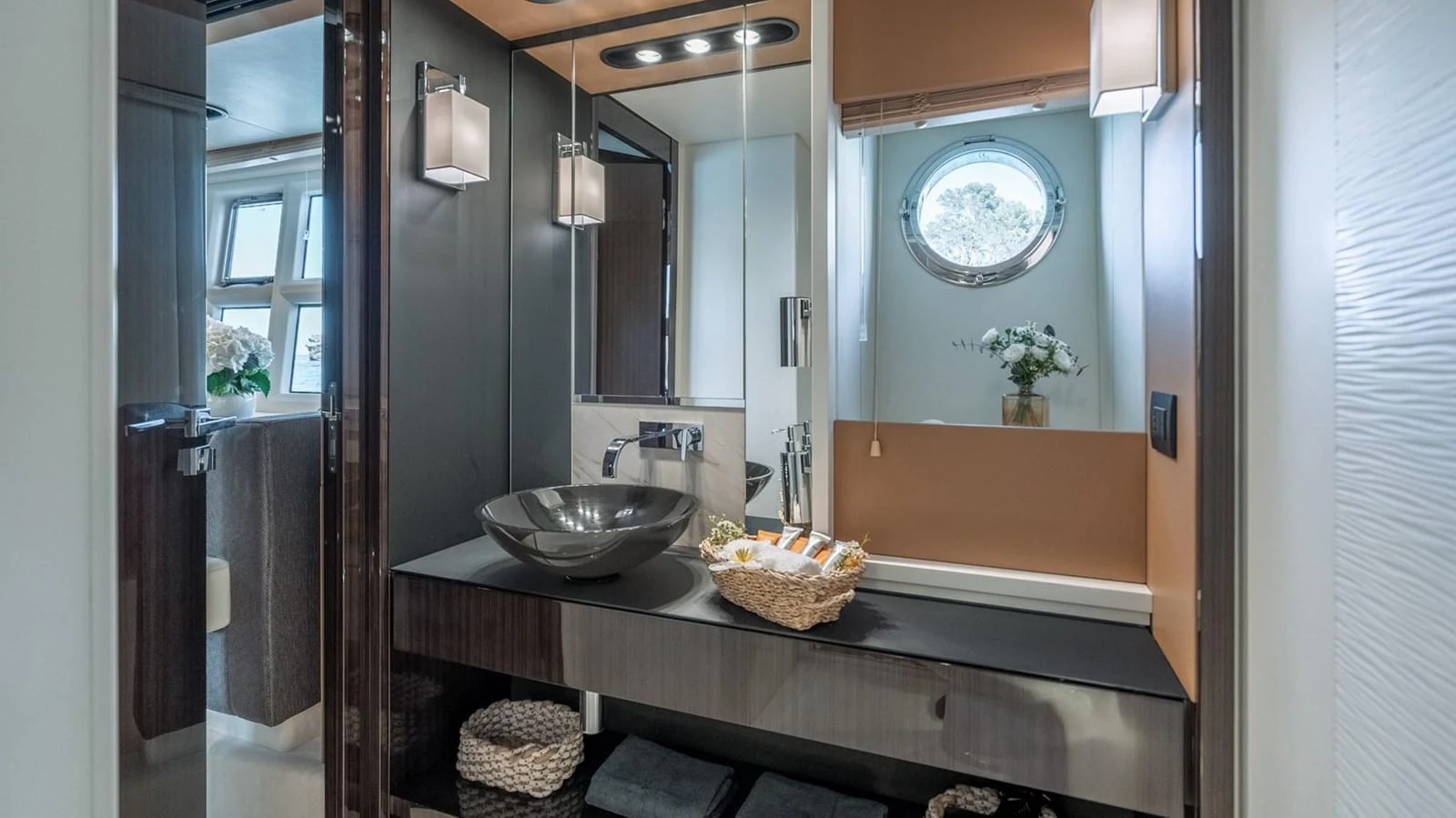 The yacht's bathroom features modern fixtures and a stylish design with a vessel sink and ample storage. aboard GRAN ABE II Yacht for Sale