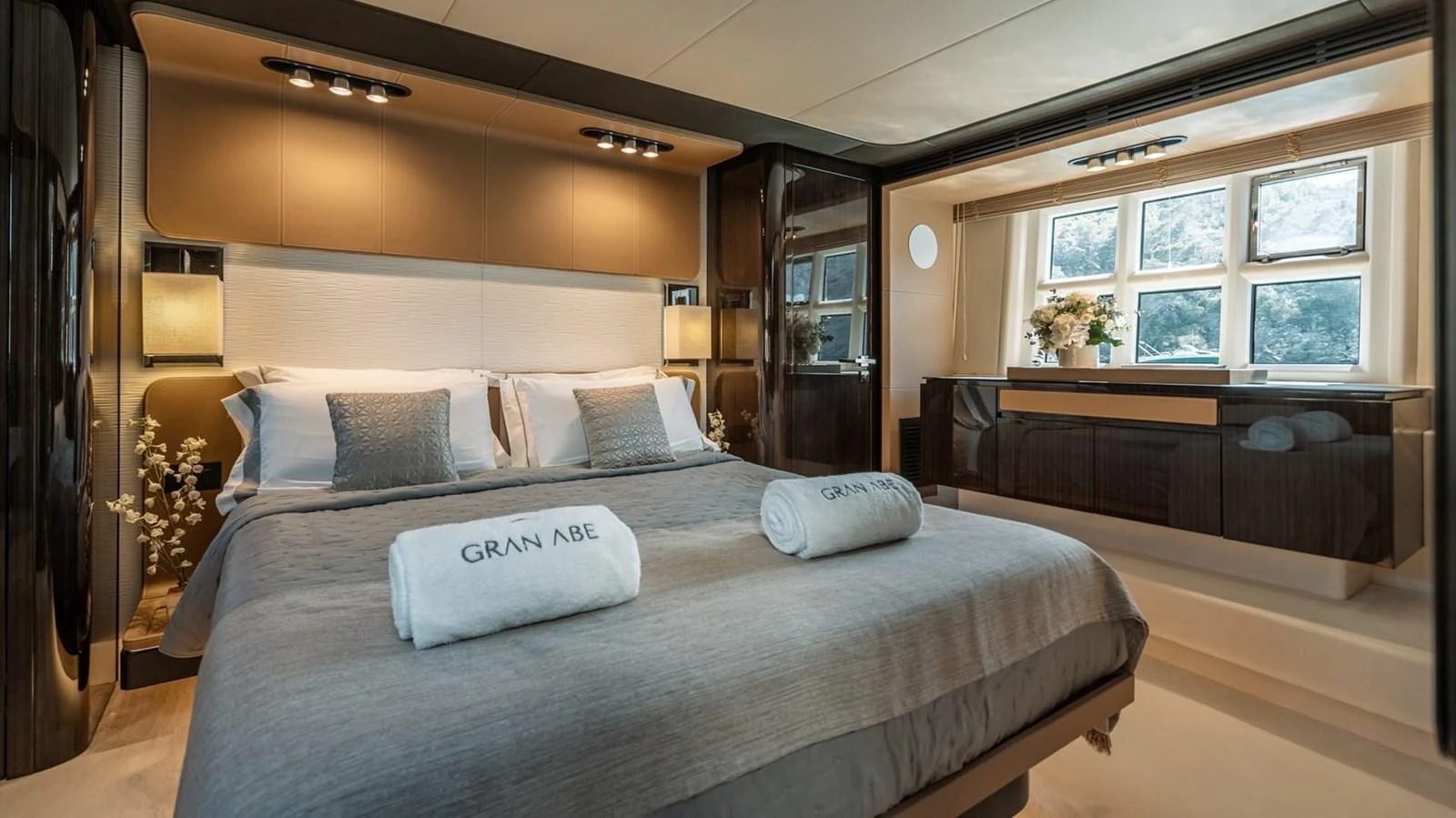 The master stateroom features a luxurious bed with elegant decor and ample natural light. aboard GRAN ABE II Yacht for Sale