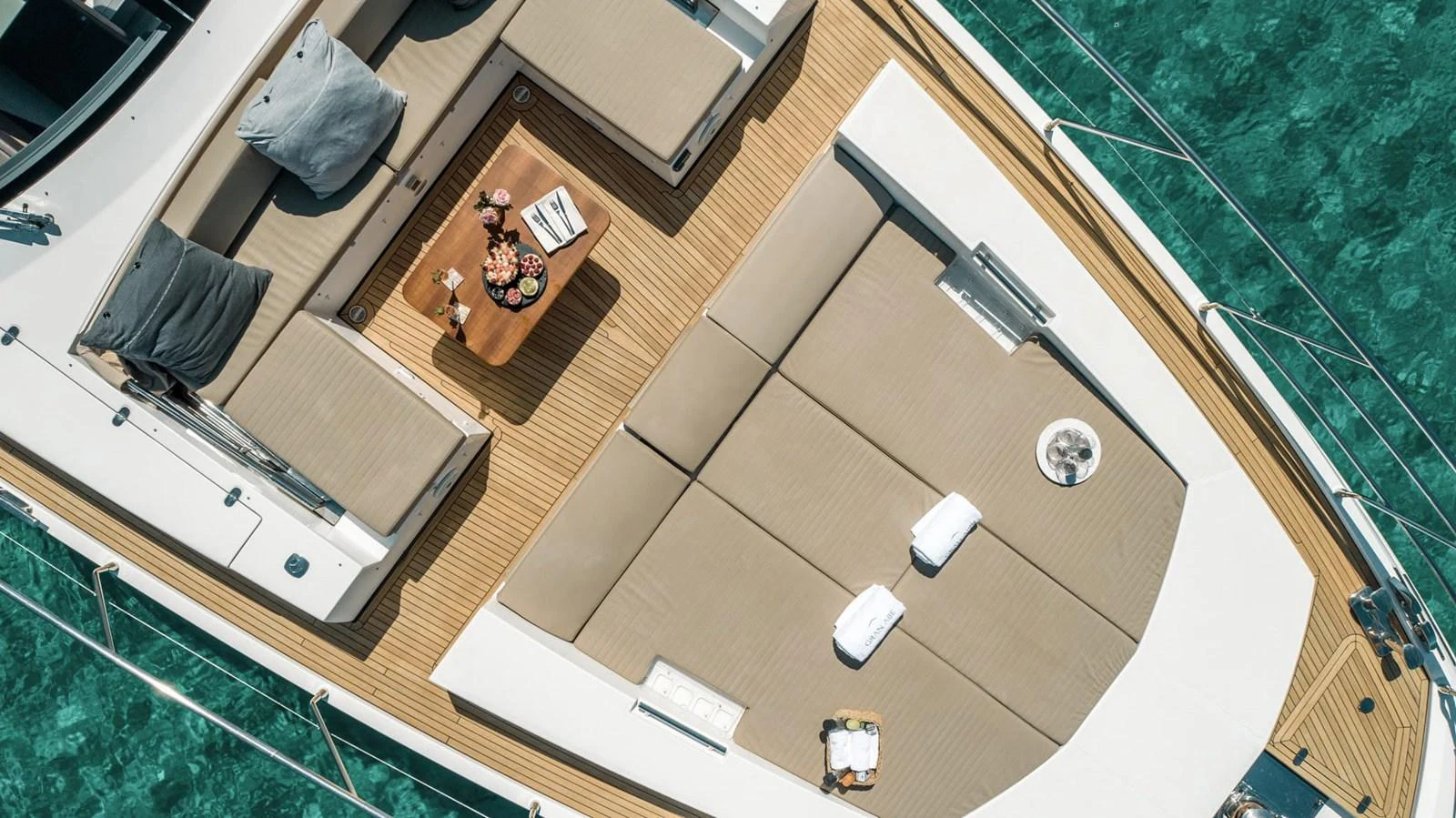 The foredeck features luxurious sun pads and a stylish seating area, perfect for relaxation. aboard GRAN ABE II Yacht for Sale
