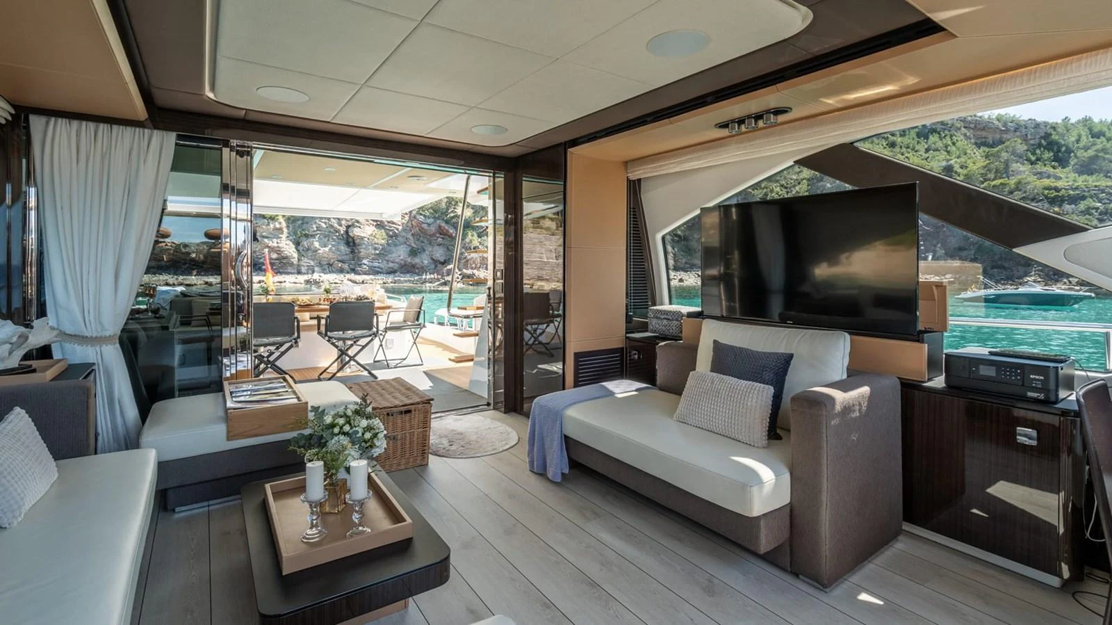 The yacht's salon offers a spacious and luxurious area with comfortable seating and a large TV, seamlessly connected to the aft deck. aboard GRAN ABE II Yacht for Sale