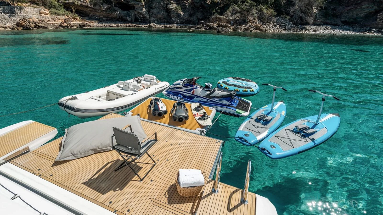 The yacht's swim platform is equipped with various water toys and a comfortable lounging area, perfect for enjoying the clear turquoise waters. aboard GRAN ABE II Yacht for Sale
