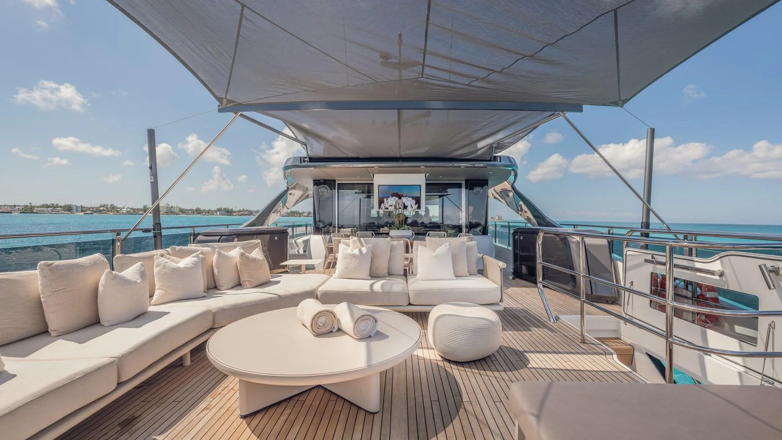 a large white lounge chair on a deck overlooking a large body of water aboard GEMINI Yacht for Sale