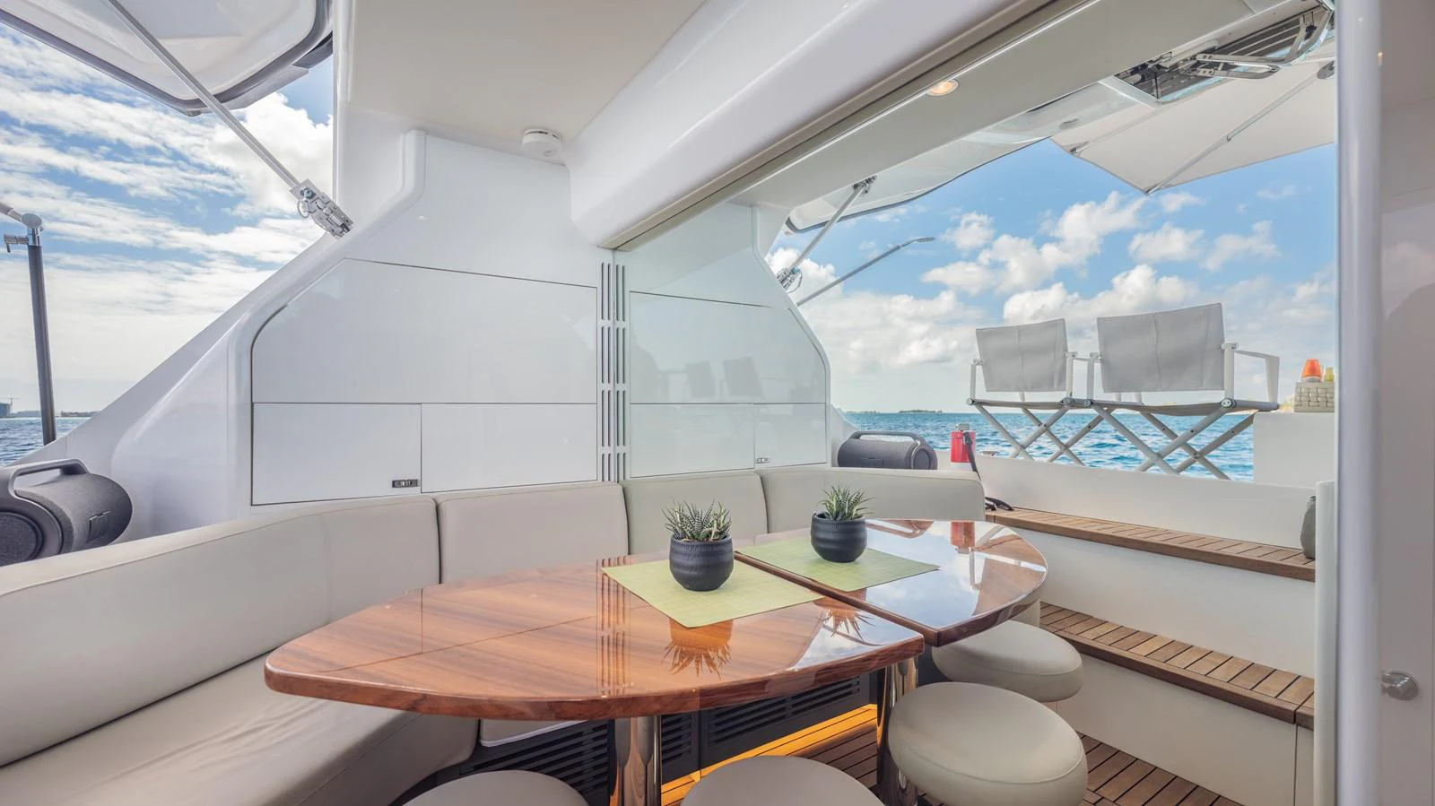a table with chairs and a view of the ocean aboard GEMINI Yacht for Sale
