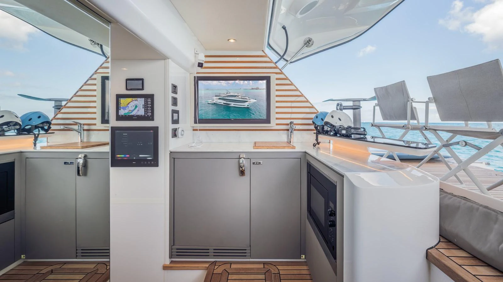 a kitchen with a sink and a tv aboard GEMINI Yacht for Sale