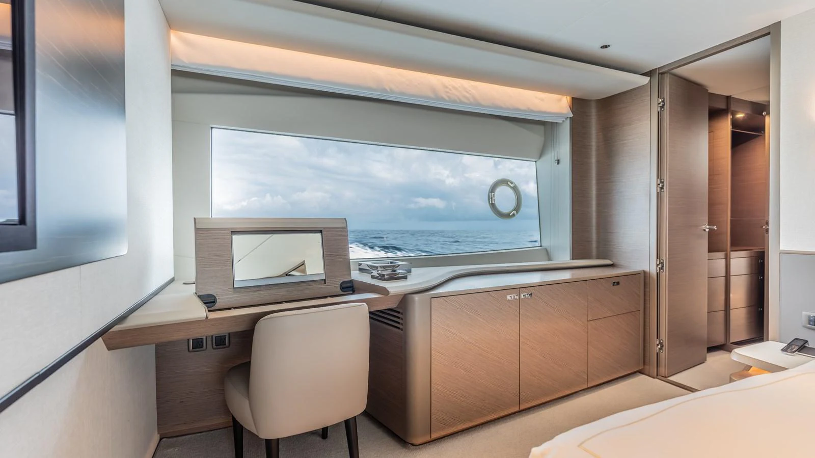a room with a desk and a large window aboard GEMINI Yacht for Sale
