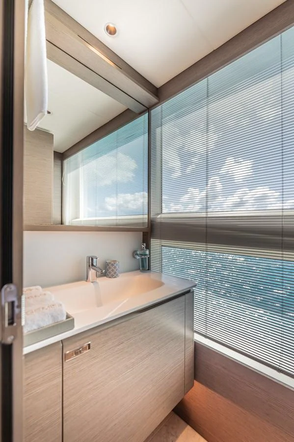 a bathroom with a sink and a window aboard GEMINI Yacht for Sale