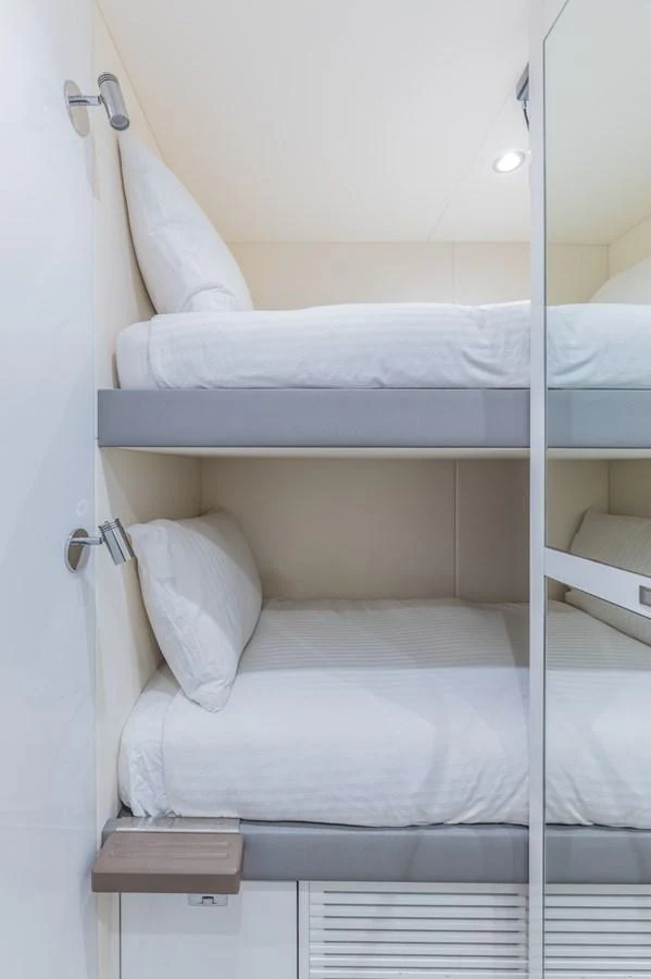 a bed with white sheets aboard GEMINI Yacht for Sale