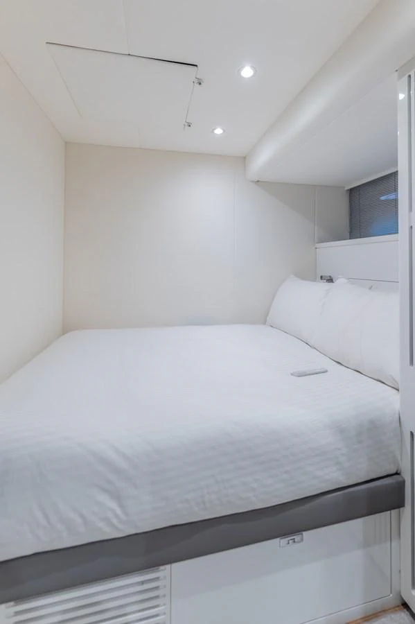 a bed with white sheets aboard GEMINI Yacht for Sale
