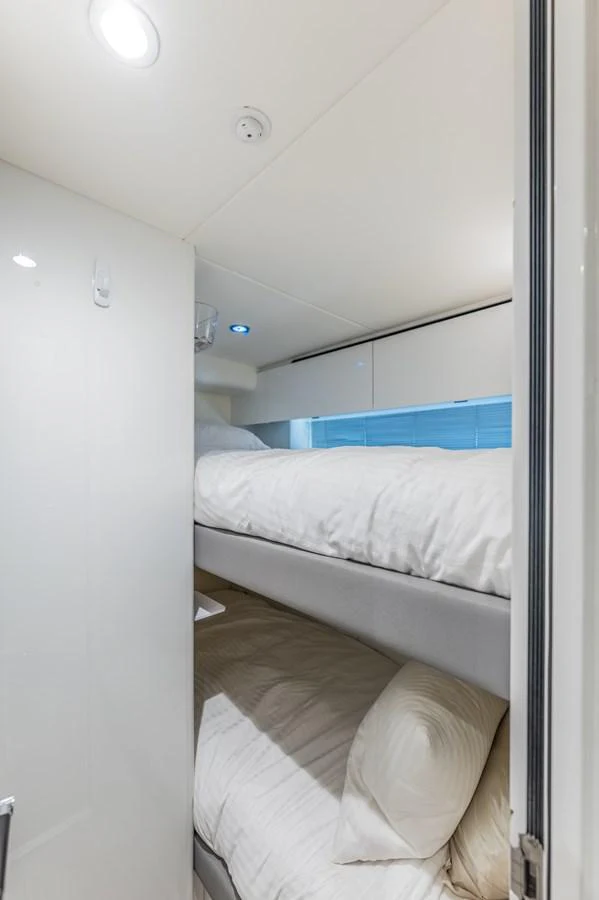 a room with a bed and a mirror aboard GEMINI Yacht for Sale