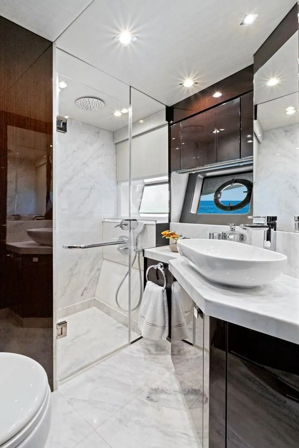The yacht's bathroom features luxurious marble finishes and modern fixtures. aboard SMITTEN Yacht for Sale