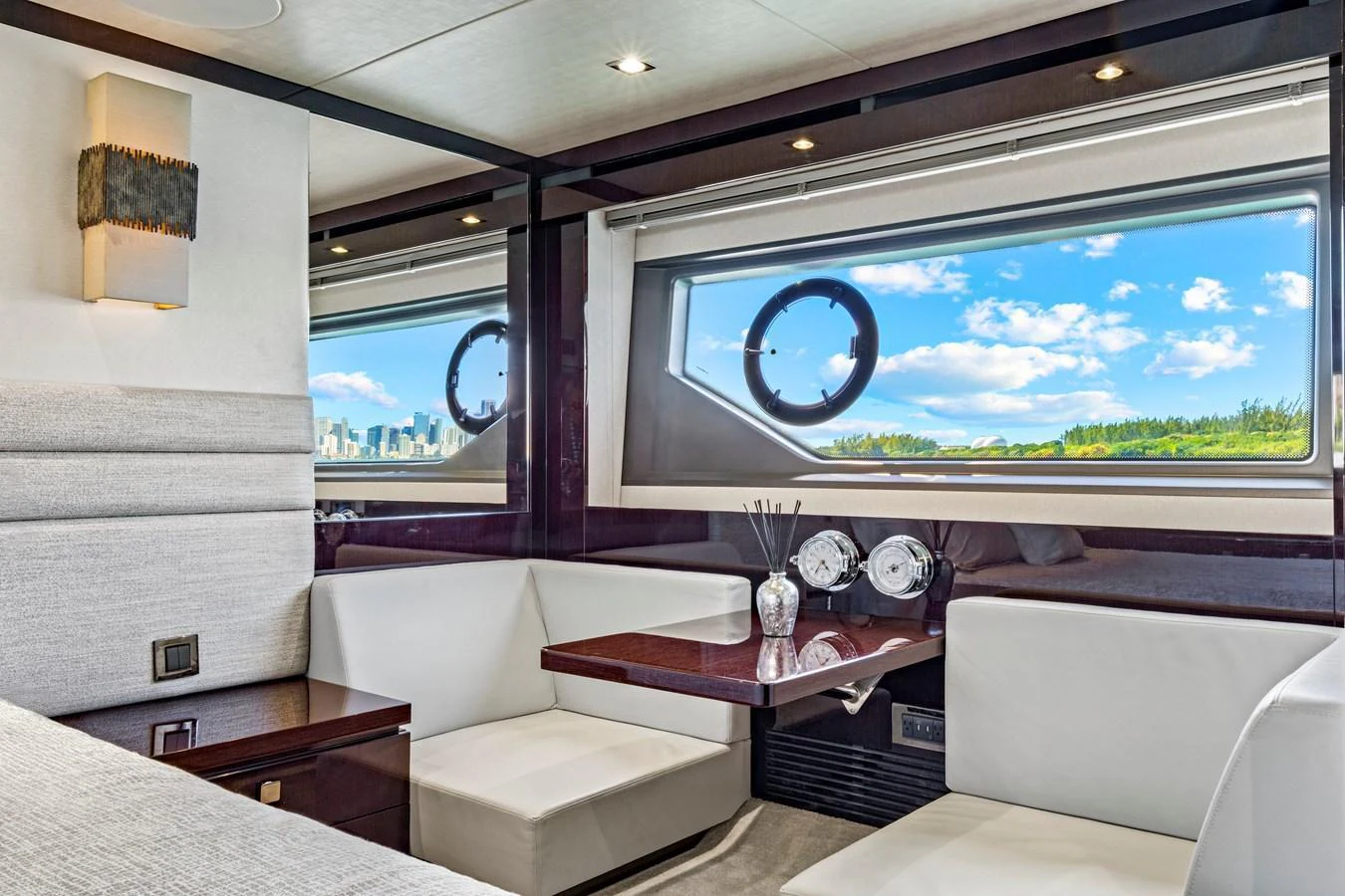 The salon features plush seating and a large window offering stunning views. aboard SMITTEN Yacht for Sale