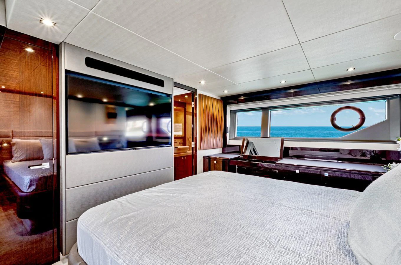 The stateroom offers a luxurious and serene retreat with a stunning ocean view. aboard SMITTEN Yacht for Sale