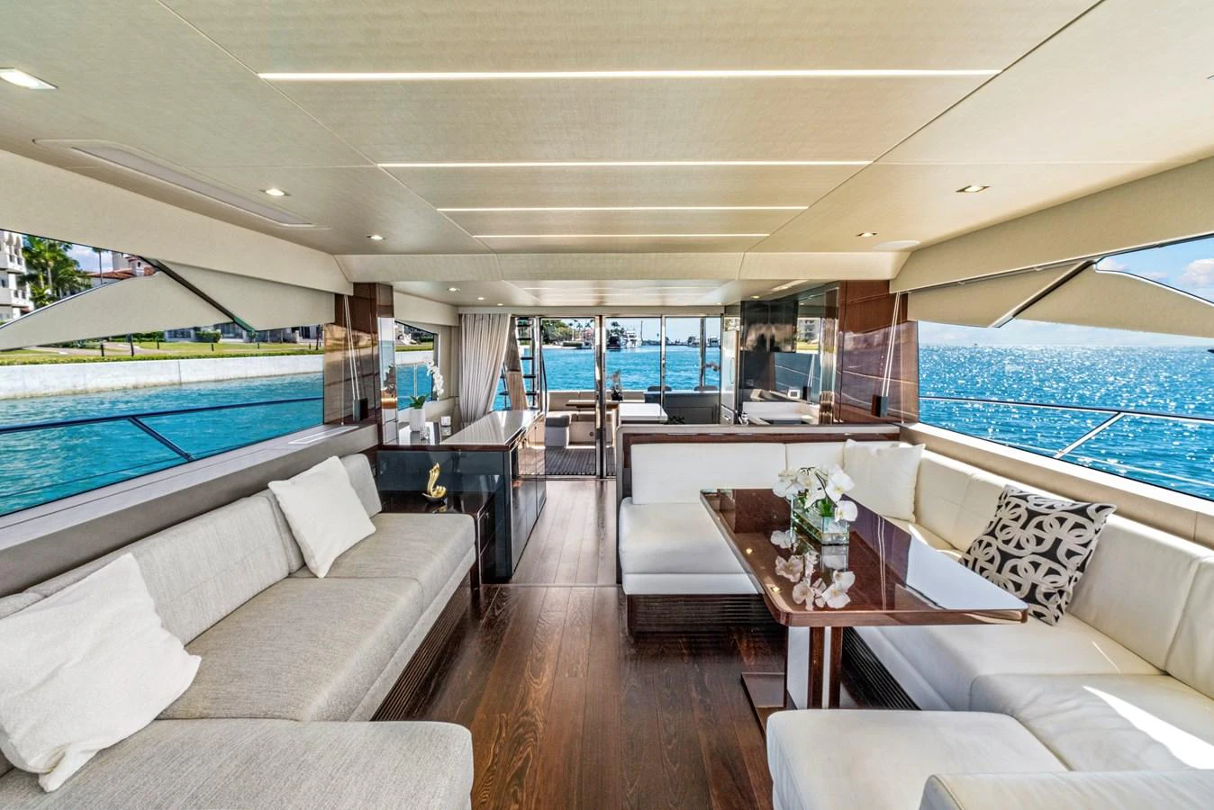 The salon offers a spacious and luxurious seating area with panoramic views of the water. aboard SMITTEN Yacht for Sale