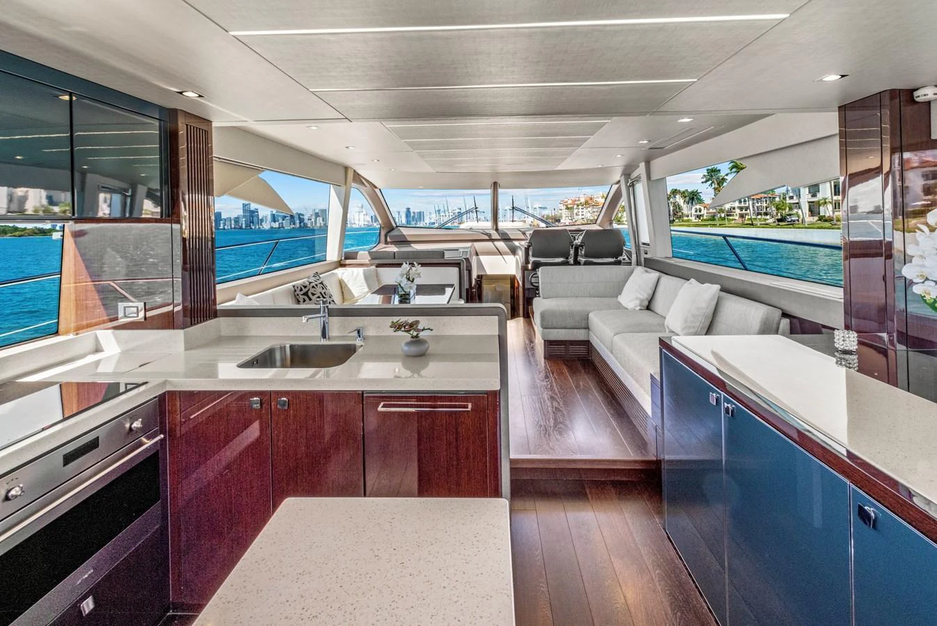 The yacht's galley features modern appliances and a spacious layout with a view of the water. aboard SMITTEN Yacht for Sale