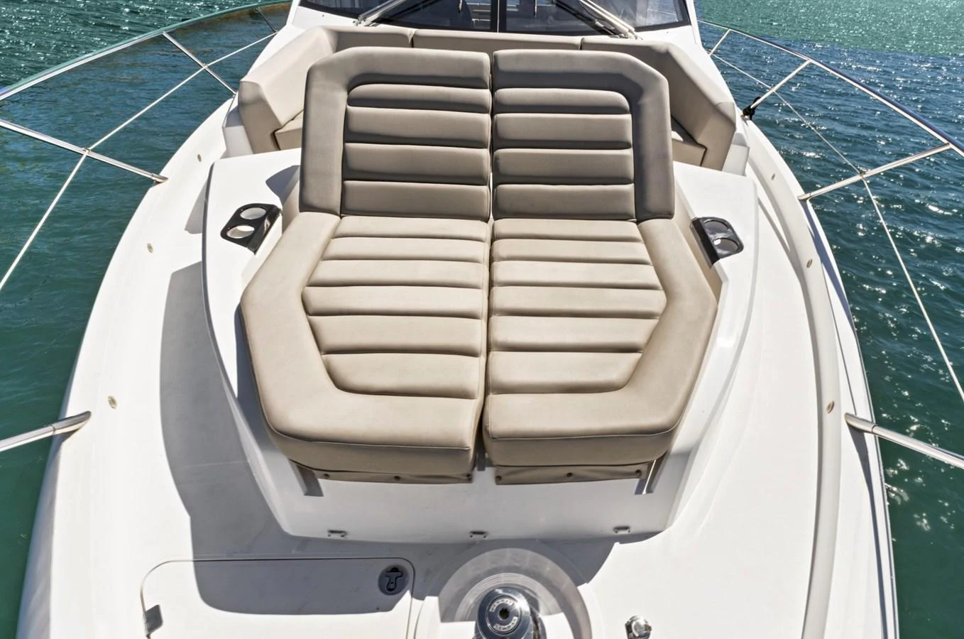 The yacht's foredeck features a spacious sunpad with plush, cushioned seating for ultimate relaxation. aboard SMITTEN Yacht for Sale