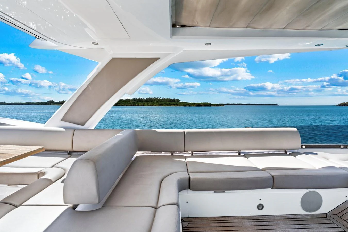 The yacht's aft deck offers a luxurious seating area with stunning views of the water and sky. aboard SMITTEN Yacht for Sale
