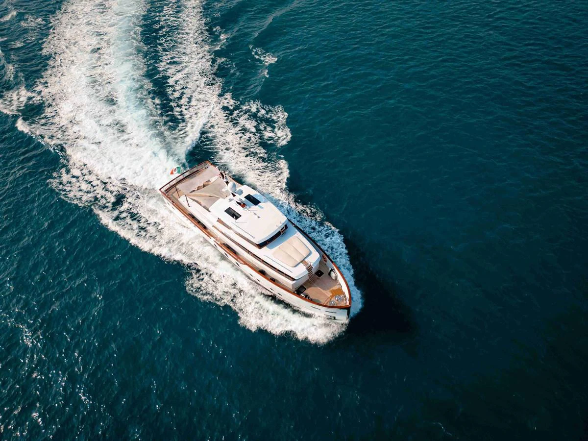A sleek yacht cruises through the open water, leaving a trail of white foam in its wake. aboard VERO Yacht for Sale