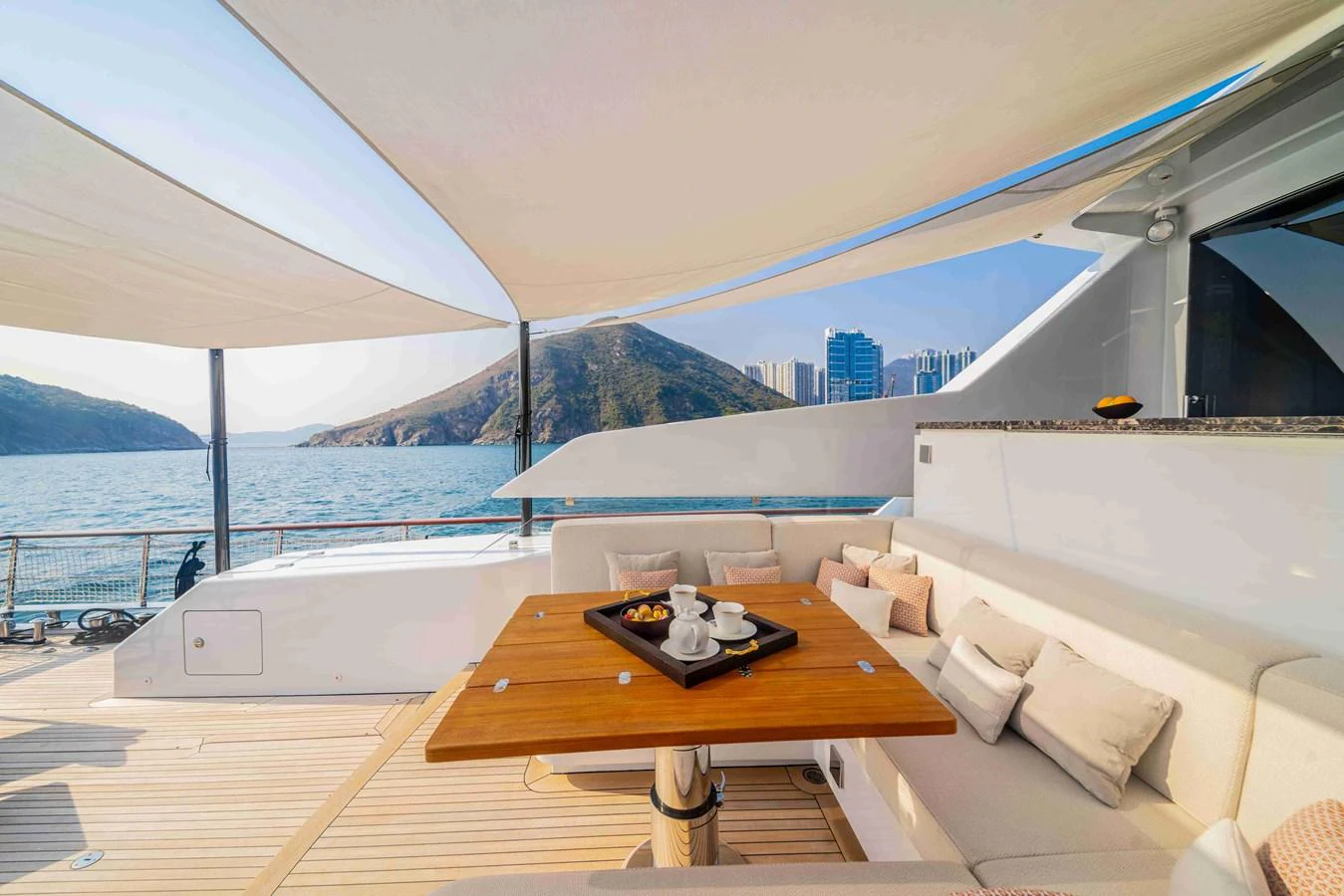 The aft deck offers a luxurious seating area with a table set for refreshments, shaded by elegant canopies. aboard VERO Yacht for Sale