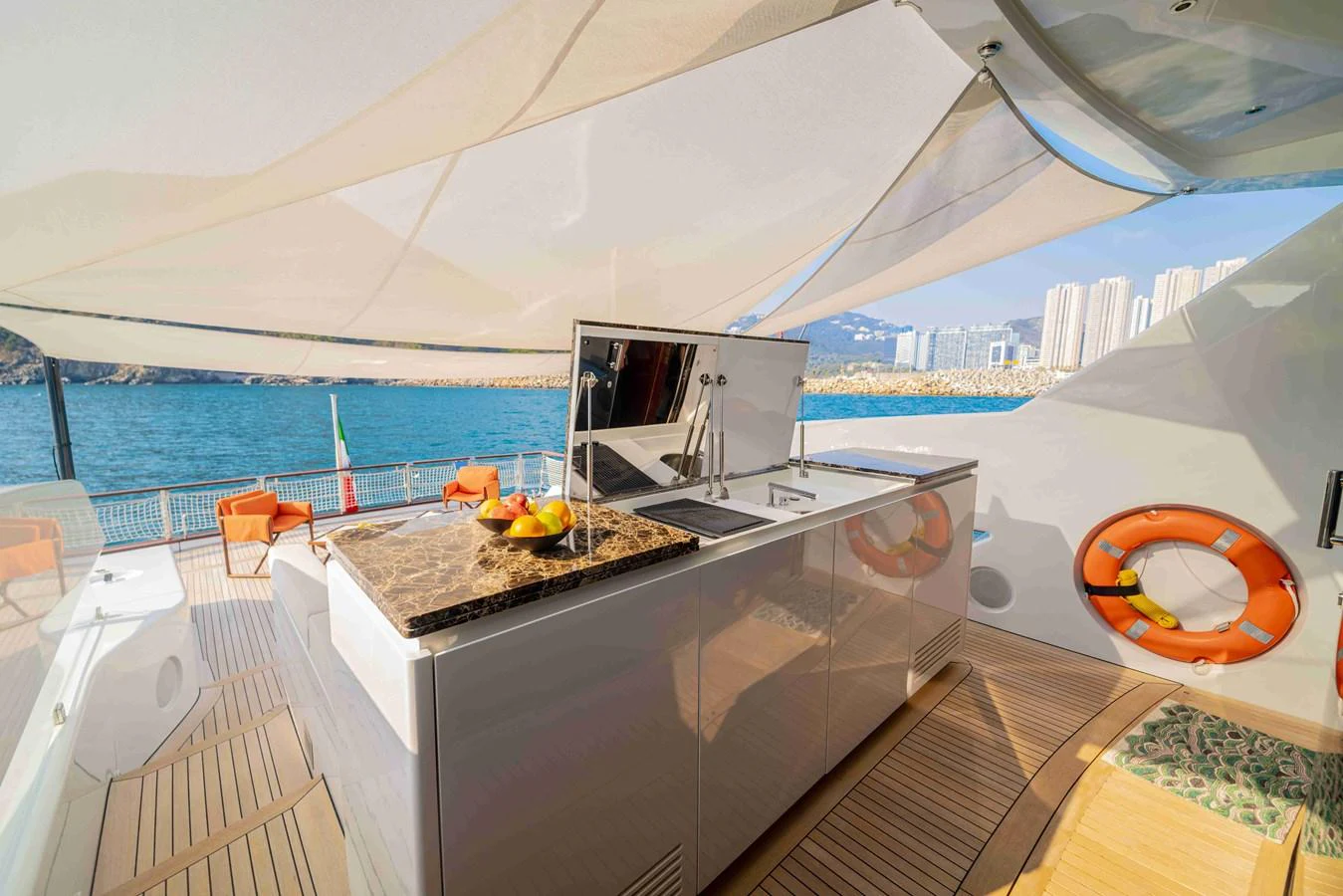 The yacht features a stylish outdoor galley with a marble countertop and modern amenities, perfect for alfresco dining. aboard VERO Yacht for Sale