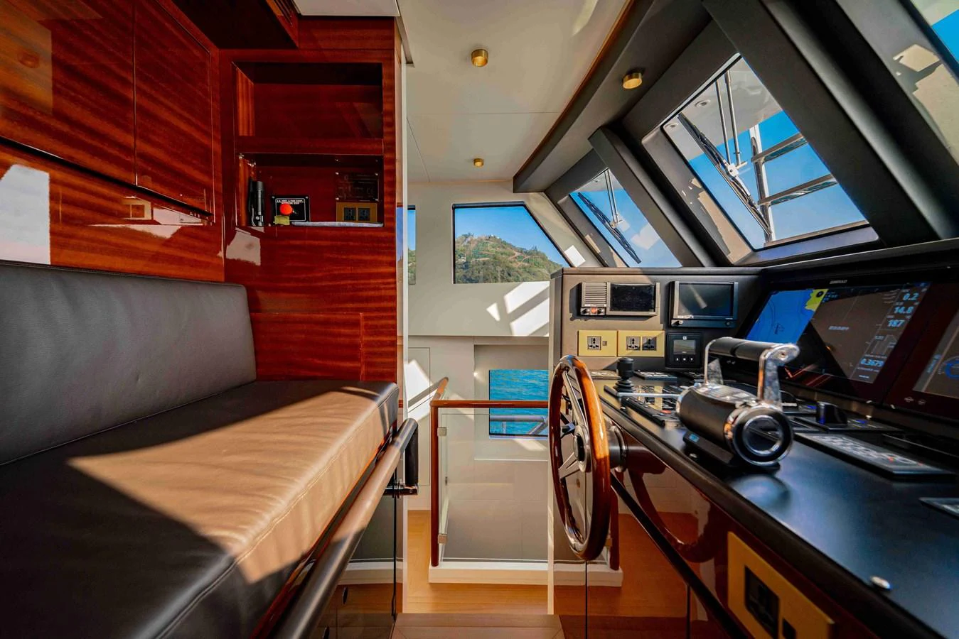 The helm station features a luxurious leather seat and state-of-the-art navigation equipment with panoramic windows offering stunning views. aboard VERO Yacht for Sale