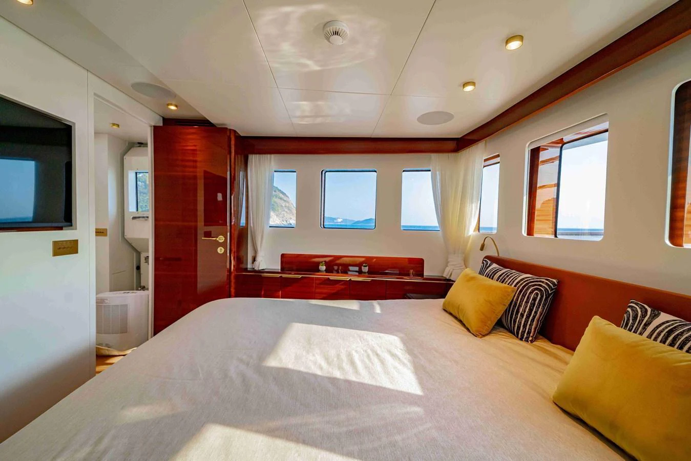 A luxurious stateroom with large windows offering stunning ocean views. aboard VERO Yacht for Sale