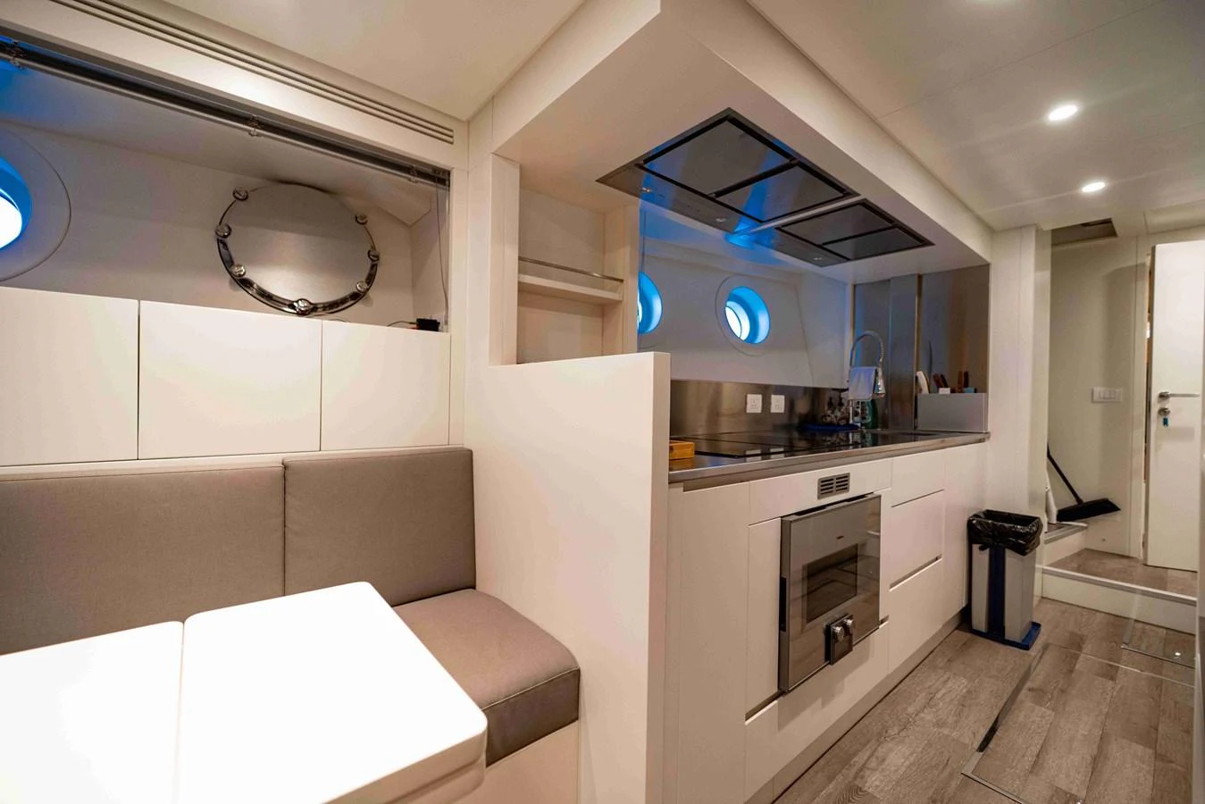 The yacht's galley is modern and well-equipped, featuring sleek cabinetry and ample seating. aboard VERO Yacht for Sale