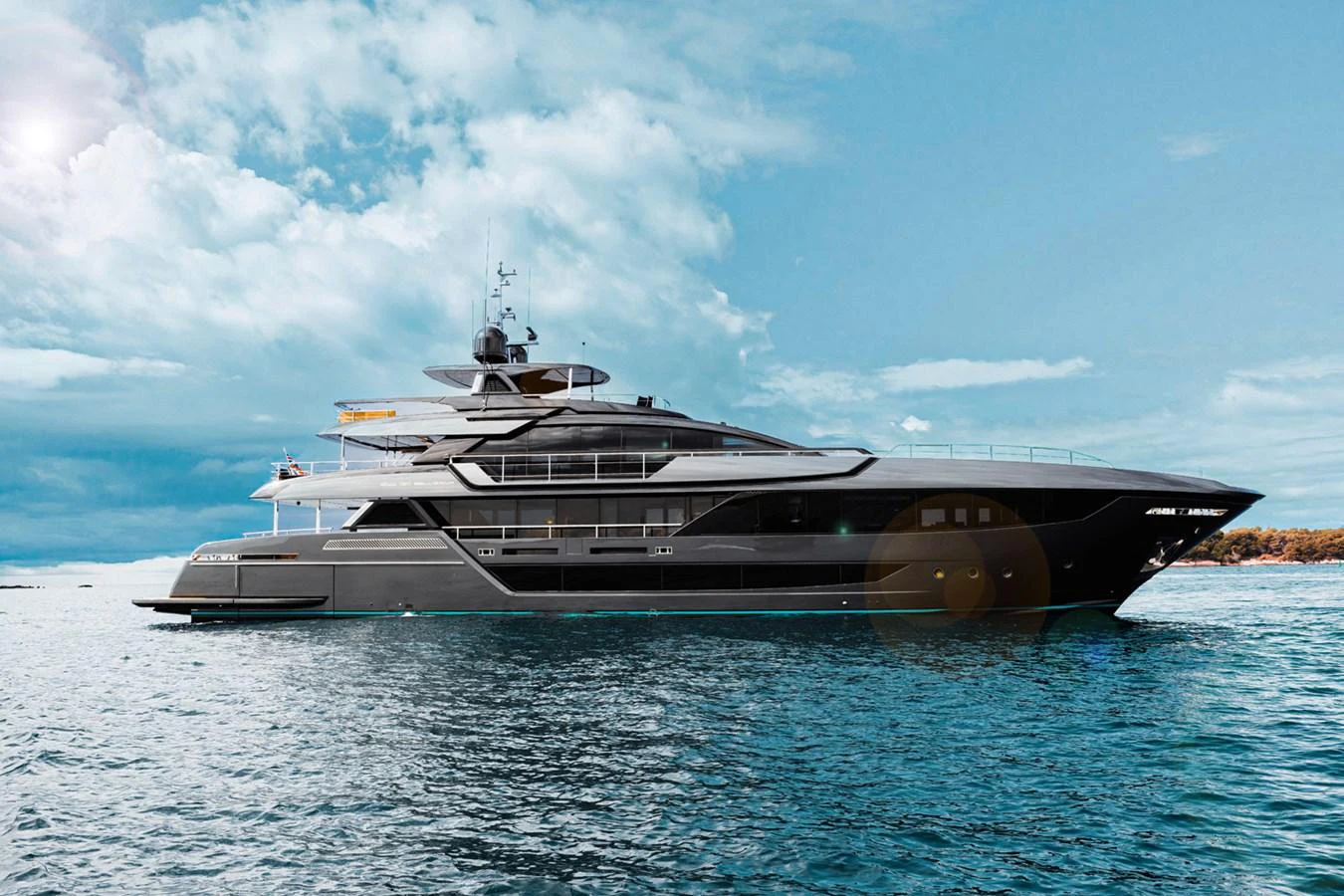A sleek and modern yacht glides gracefully on the water under a clear blue sky. aboard LADY FIRST Yacht for Sale