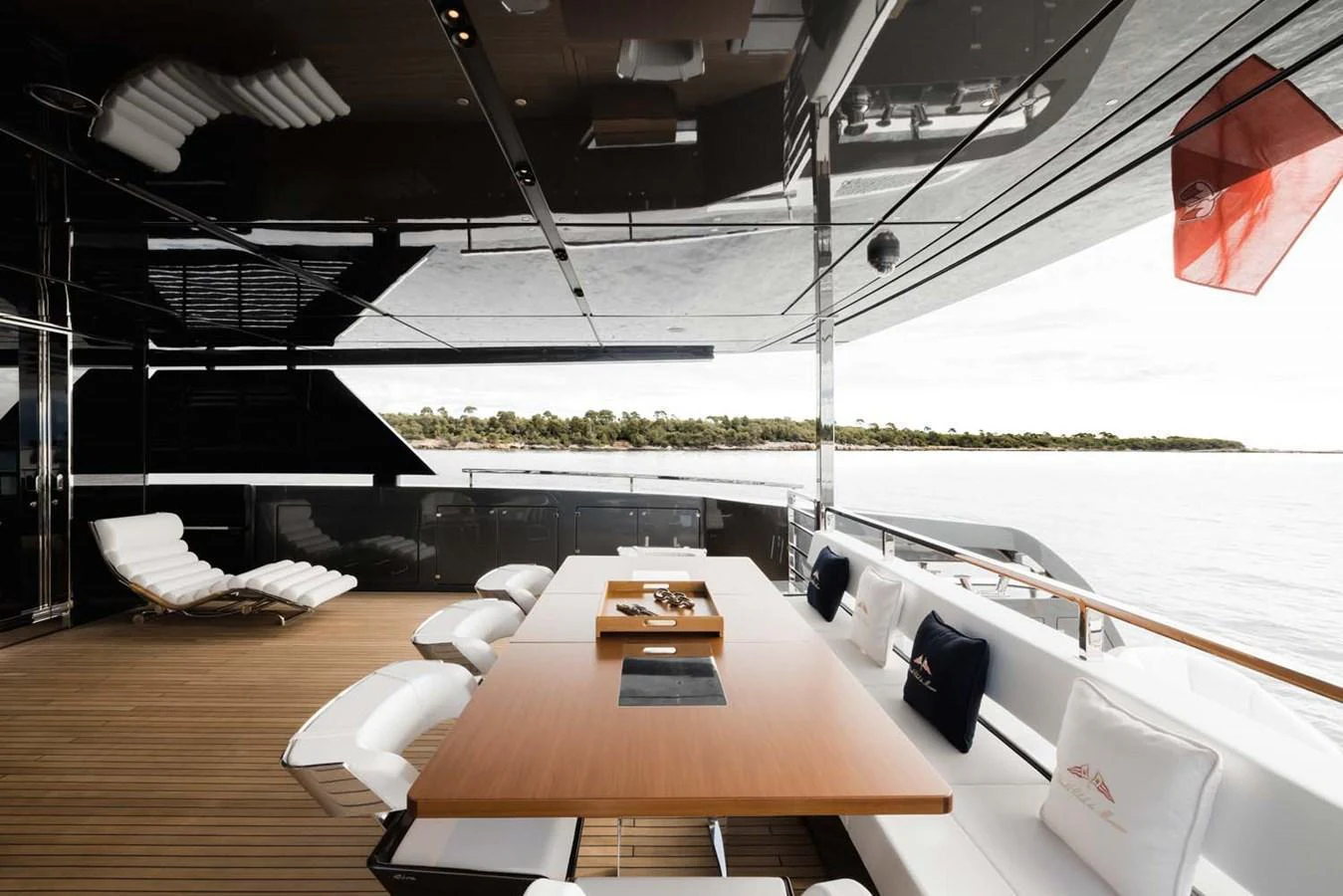 The aft deck features a stylish dining area with a sleek wooden table and comfortable seating, perfect for al fresco meals. aboard LADY FIRST Yacht for Sale