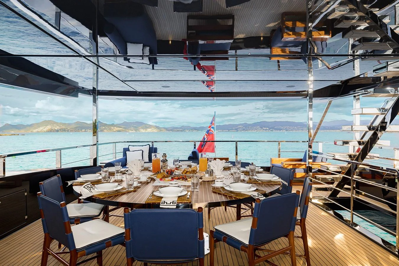 The aft deck features an elegant dining area with panoramic views of the sea. aboard LADY FIRST Yacht for Sale