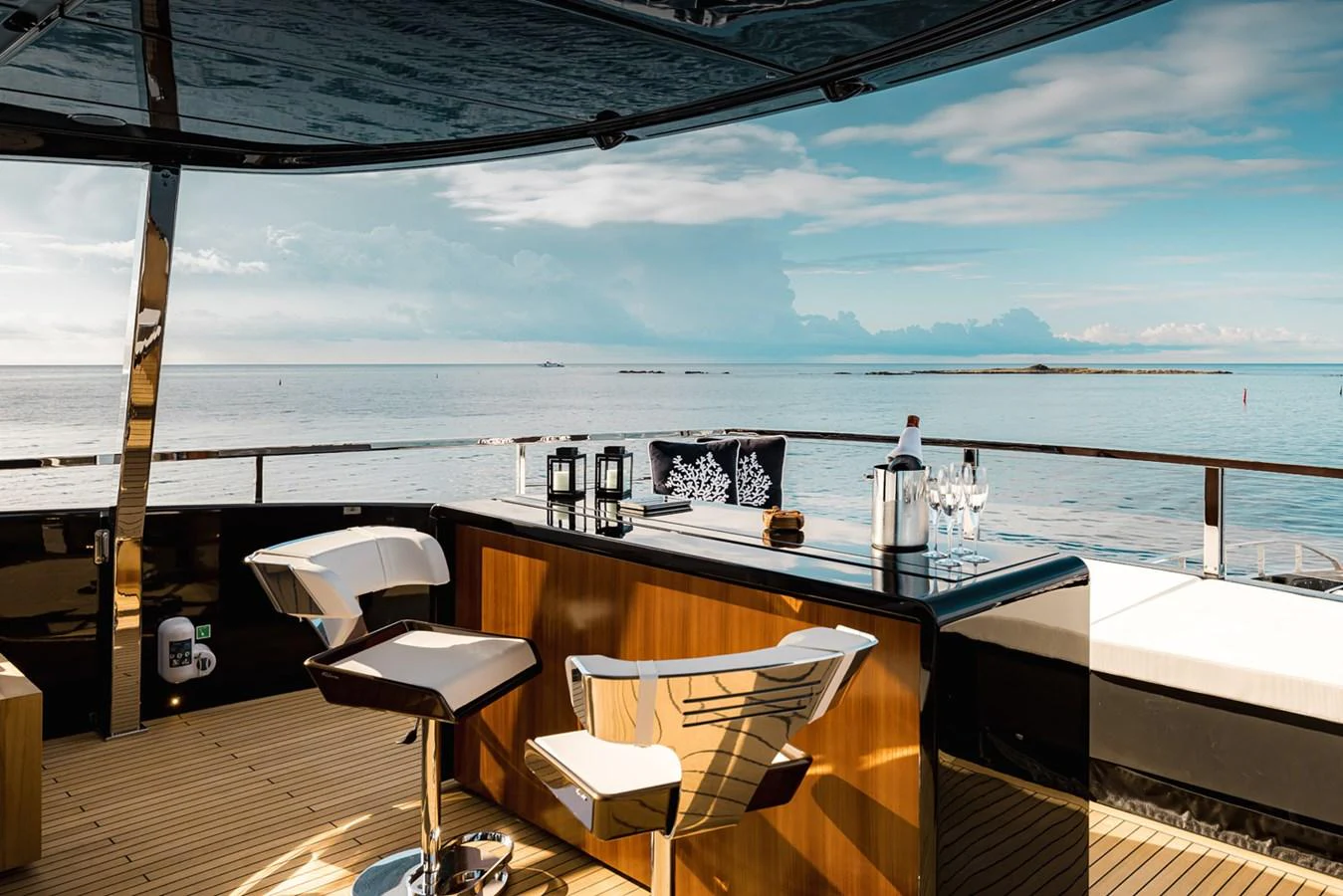 A stylish bar area on the deck of a yacht, offering a serene view of the sea. aboard LADY FIRST Yacht for Sale