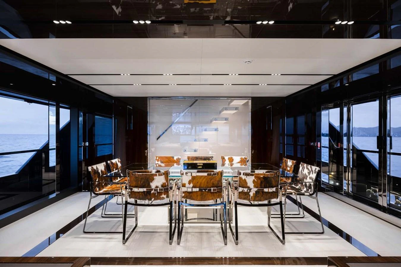 The yacht's dining area features a sleek, modern design with panoramic views. aboard LADY FIRST Yacht for Sale