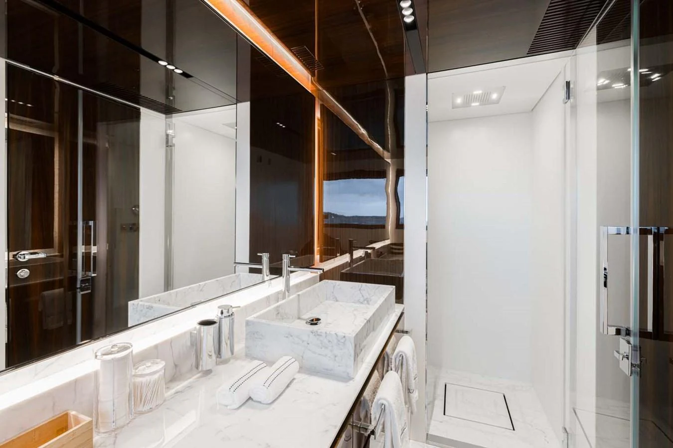 The yacht's bathroom features a sleek, modern design with a marble countertop and a spacious shower area. aboard LADY FIRST Yacht for Sale
