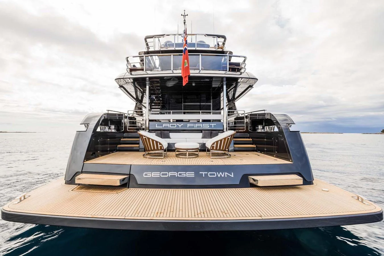 The yacht's aft deck features a spacious lounging area with elegant seating and a sleek design. aboard LADY FIRST Yacht for Sale