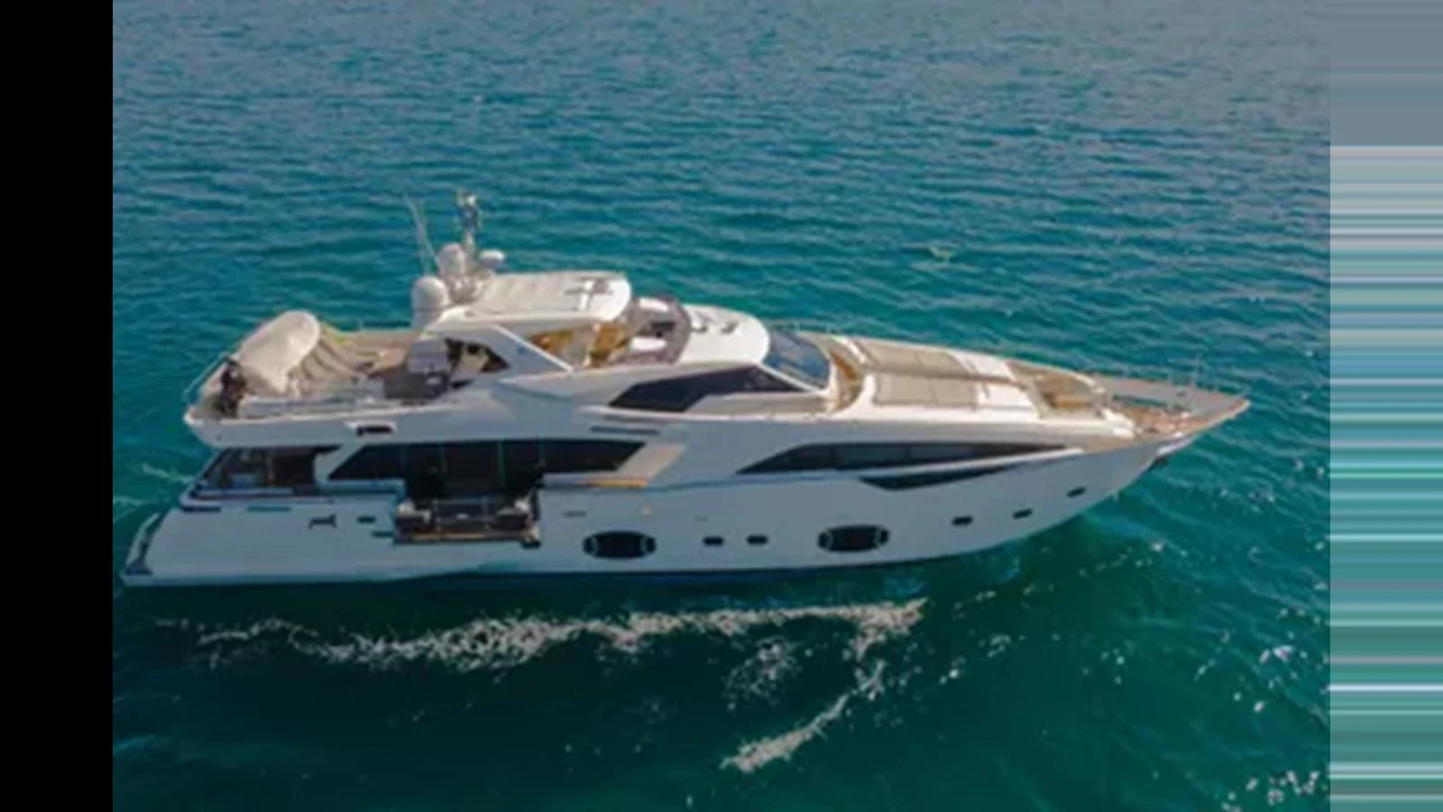 A luxurious yacht glides gracefully on the serene blue waters, showcasing its sleek design and spacious decks. aboard AMORE MIO Yacht for Sale
