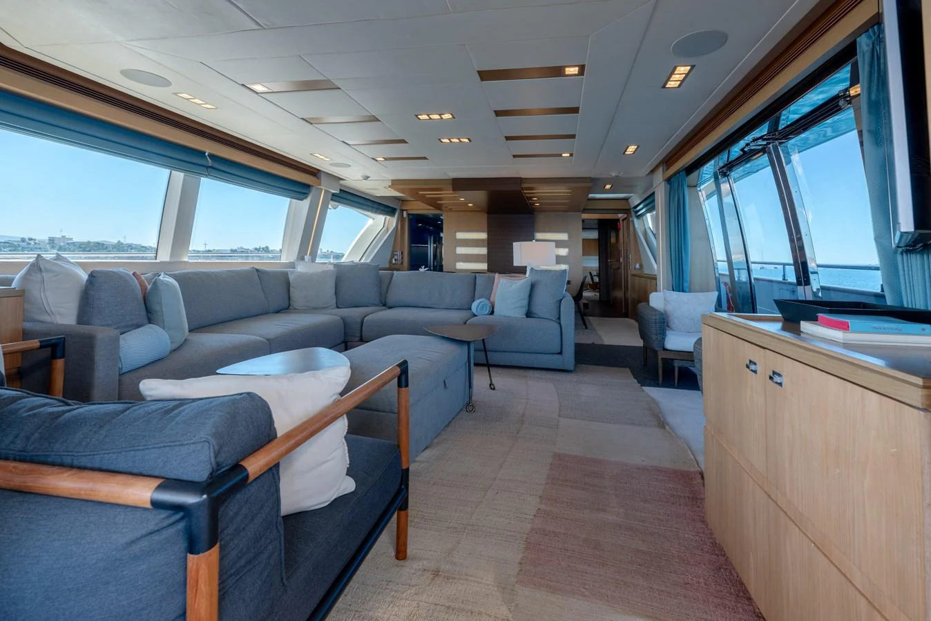 The spacious salon features ample seating with large windows providing stunning views. aboard AMORE MIO Yacht for Sale