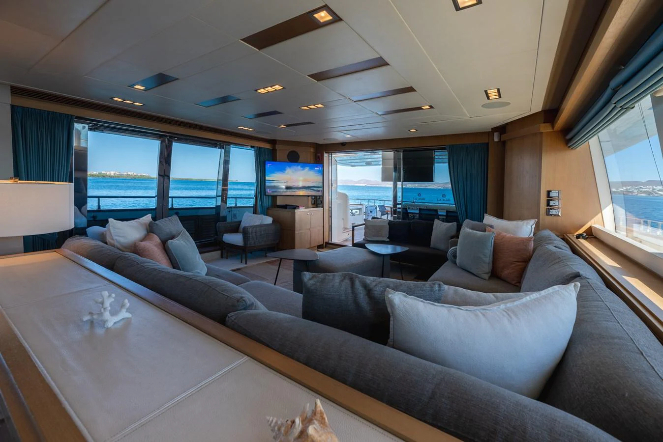 The salon offers a spacious and luxurious seating area with panoramic views of the sea. aboard AMORE MIO Yacht for Sale