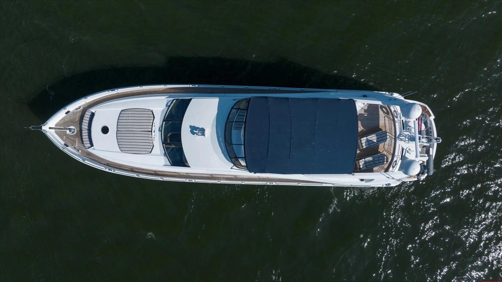 A sleek yacht is captured from above, showcasing its streamlined design and spacious deck areas. aboard VANGUARD Yacht for Sale